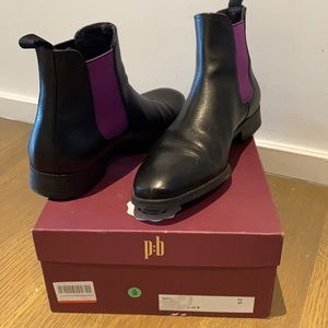 Men’s black leather boot with purple accent .